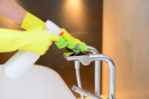 Local cleaner inspecting and pre-treating a sofa in Brent